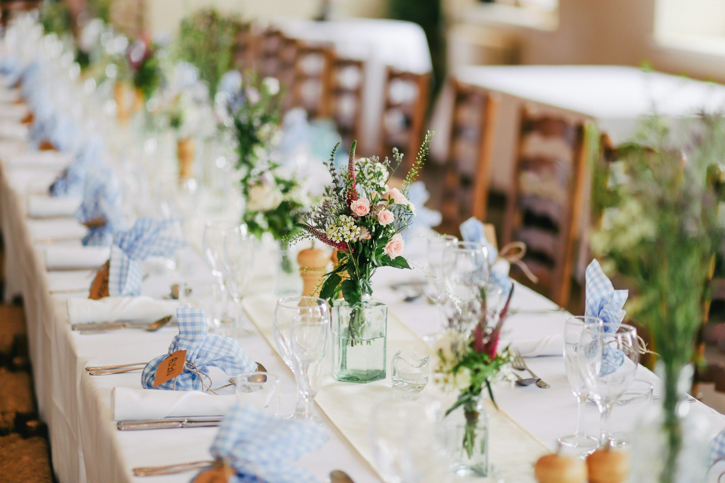 Wedding vendor booth at a bridal expo with couples browsing